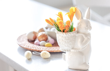 Obraz na płótnie Canvas Easter still life with a ceramic hare, eggs and flowers.