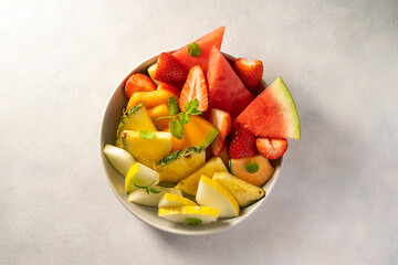 Summer fruits assortment platter antipasti, watermelon, pineapple, melon and strawberries. 