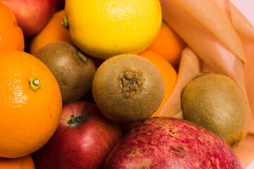 Various fruits in a reusable bag close-up. Earth day and zero waste concept.