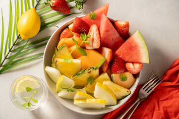 Summer fruits assortment platter antipasti, watermelon, pineapple, melon and strawberries. 