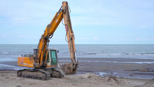 Crawler excavator moves on the beach