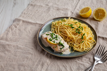 Homemade Creamy Lemon Chicken in a Pan, side view. Copy space.