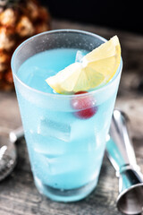 Deep blue sea martini cocktail on wooden table