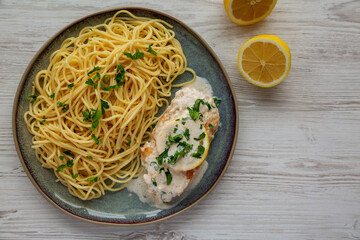 Homemade Creamy Lemon Chicken in a Pan, top view. Flat lay, overhead, from above.