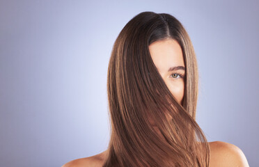 Woman, beauty and hair portrait in studio for space, growth and healthy shine on blue background. Aesthetic female model for haircare texture, self care and cosmetic results for salon or hairdresser