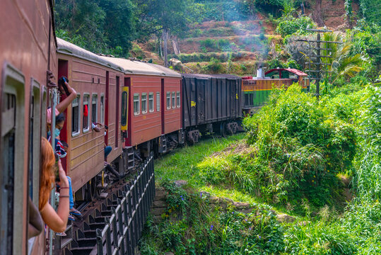 Train winding on a hillside track among tea plantations at Sri Lanka