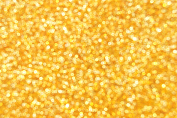 Golden defocused glitter texture as background
