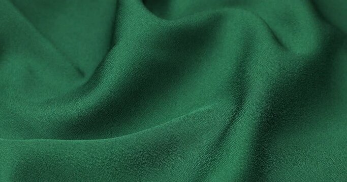 Green fabric background. Green cloth waves background texture. Green fabric cloth textile material.