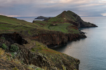 Ponta de Sao Lourenco, Madeira , Portugal. Sunrise over green cliffs and spring flowers at Atlentic Ocean