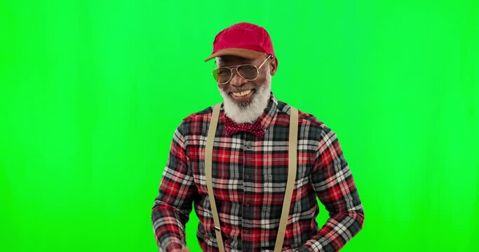 Dance, music and a senior black man on a green screen background in studio having fun moving with rhythm. Party, fashion and funky with a happy elderly man dancing on chromakey mockup for freedom