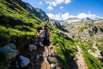 Young hiker girl summit to Ratera Peak in Aiguestortes and Sant Maurici National Park, Spain