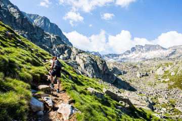 Young hiker girl summit to Ratera Peak in Aiguestortes and Sant Maurici National Park, Spain