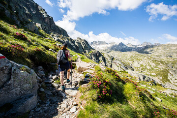 Fototapeta premium Young hiker girl summit to Ratera Peak in Aiguestortes and Sant Maurici National Park, Spain