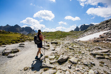 Young hiker girl summit to Ratera Peak in Aiguestortes and Sant Maurici National Park, Spain