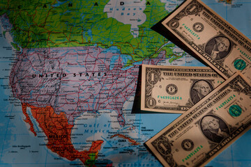 a map of the USA with one dollar notes arranged in an arrow pointing in the direction of financial...