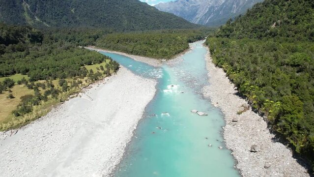 Beautiful colouful scene of confluence two rivers and pristine forest, New Zealand natural landscape - drone shot