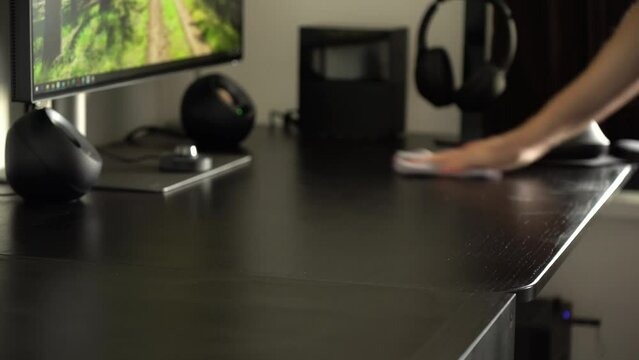 A man wipes an office table with a cloth - closeup - timelapse