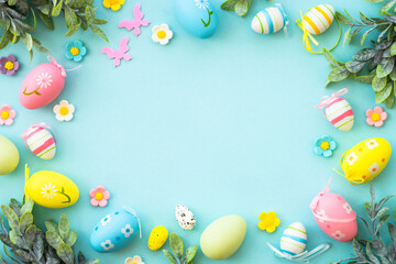 Easter background with Eggs and spring flowers at blue background.