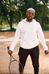 Black man with racquet pose on court