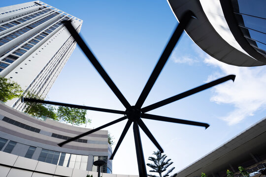 HVLS (High Volume Low Speed) fan located at cafe outdoor area. HLVS fans circulate air more efficiently and provide substantially more airflow. Outdoor fan, Industrial fan.