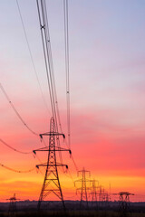 Portrait view of evening sky with power pylons silhouetted