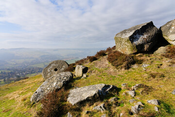 Lichen covered boulders and abandoned mill stones on Curbar Edge.