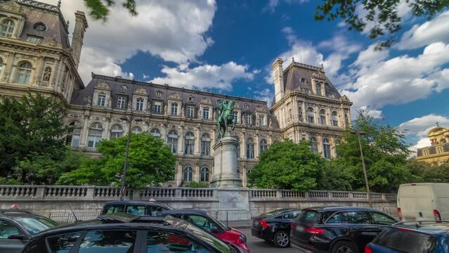 The bronze statue of Etienne Marcel proudly standing beside the Hotel de Ville timelapse hyperlapse, Paris, France. Traffic on the street near monument. Blue sky at summer day