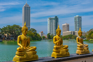 Golden buddha statues at Gangarama Seema Malakaya buddhist temple at Colombo, Sri Lanka