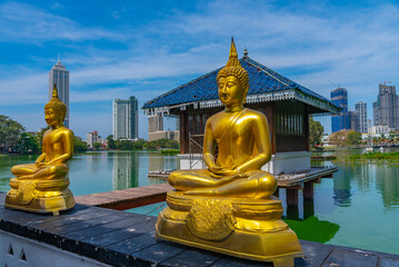 Golden buddha statues at Gangarama Seema Malakaya buddhist temple at Colombo, Sri Lanka