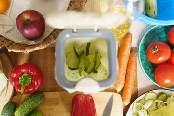 Organic food waste in a compost bin. Sustainable lifestyle and zero waste concept. Specialized...