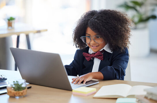 Laptop, happy and a child pretending to be an employee, reading emails and playing on a computer. Smile, smart and a little girl typing on a pc to play pretend and acting as an office worker