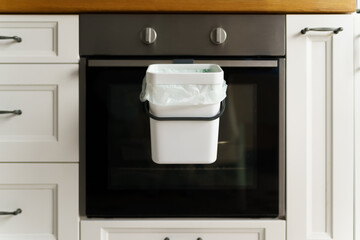 Fototapeta premium Compost bin in a domestic kitchen. Bokashi container for biodegradable food leftovers. Recycle organic waste into natural fertilizer