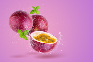 Creative layout made from Fresh passionfruit  and water Splashing on a pink background.