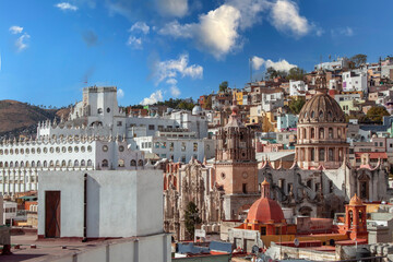 Ancient towers, La Valenciana church, and University buildings from El Pípila. Panorama city with colorful historical old town buildings in Guanajuato Mexico. Mexican colonial neighborhood houses.