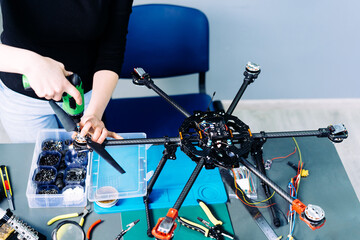 Fototapeta na wymiar Engineer working on racing fpv drone combat kamikaze bomber in workshop.