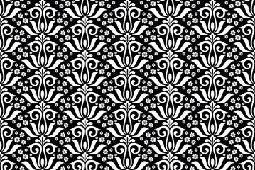 Wallpaper in the style of Baroque. Seamless vector background. White and black floral ornament. Graphic pattern for fabric, wallpaper, packaging. Ornate Damask flower ornament