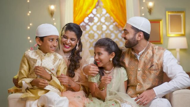 happy indian muslim family celebrating or enjoying ramadan festival at home - concept of reletionship,bonding and festival celebration.