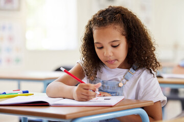 Learning, drawing and girl in classroom for education, exam or studying with book. Preschool,...