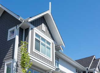 Top of residential townhouse on blue sky background