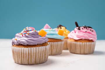 Delicious homemade cupcakes with Colorful cream and topping with candy and Chocolate Cookies. Homemade autumn holiday dessert