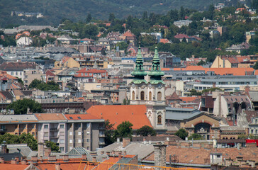 Fototapeta na wymiar Skyline of Budapest, Hungary, Europe. Rooftops of heritage buildings, towers, colorful cityscape. Historical downtown neighborhood houses, Hungarian urban landscape. Aerial view of Batthyány Square.