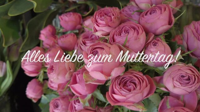 4k video of bouquet of roses with text flying in "Alles Liebe zum Muttertag!" in German language