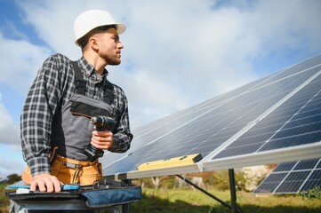 Worker installing solar panels outdoors