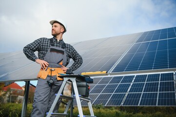 Worker installing solar panels outdoors