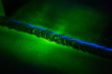 Crack steel butt weld carbon background green contrast magnetic filed