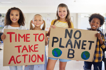 Children, portrait and poster with friends in protest in a classroom holding signs for eco friendly...