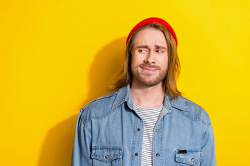 Portrait of confused funny guy with bob haircut wear denim jacket looks suspiciously into empty...