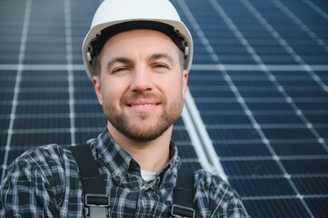Solar power plant worker checks the condition of the panels