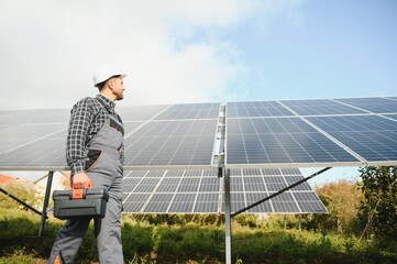 Worker installing solar panels outdoors