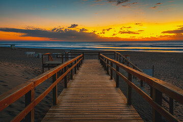 Fototapeta na wymiar wooden bridge at sunset